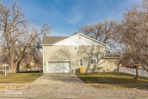 View of front of house featuring driveway and an attached garage