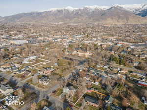 Aerial view of property's location featuring nearby suburban area and a mountainous background