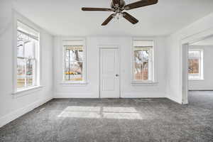 Spare room with carpet floors and ceiling fan