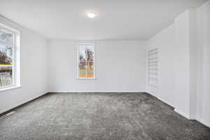 Carpeted empty room with baseboards
