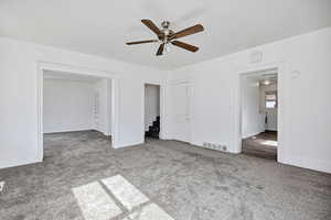 Unfurnished living room with ceiling fan and light carpet