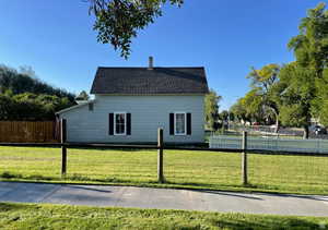 View of property exterior featuring roof with shingles and a chimney