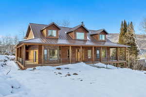 Rustic home with a porch and a metal roof