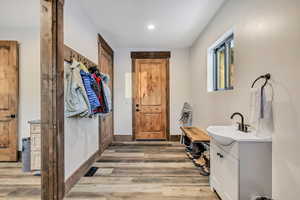 Mudroom with light wood-type flooring and recessed lighting