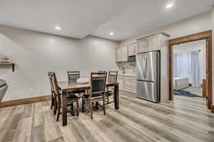 Dining room featuring light wood-style flooring and recessed lighting