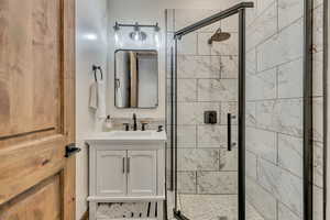 Bathroom with vanity and a stall shower