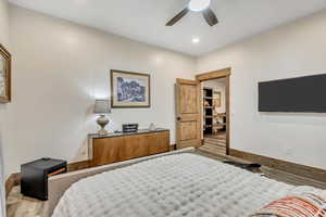 Bedroom with wood finished floors, a ceiling fan, and recessed lighting