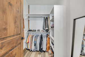Spacious closet with light wood-type flooring
