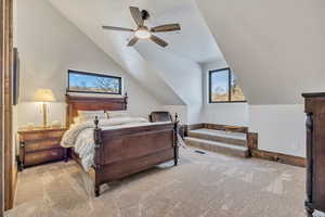 Bedroom with carpet floors, a ceiling fan, and lofted ceiling
