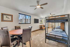 Bedroom with light colored carpet, vaulted ceiling, and a textured ceiling