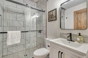 Bathroom featuring vanity and a stall shower