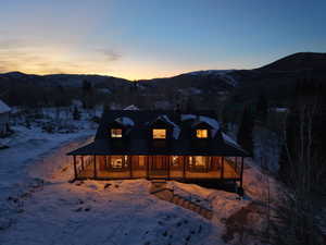View of front facade featuring a mountain view, a porch, and a metal roof