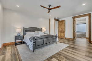 Bedroom with wood finished floors, a ceiling fan, and recessed lighting