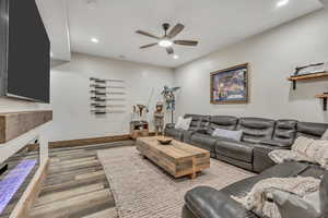 Living room featuring light wood-style floors, ceiling fan, and recessed lighting