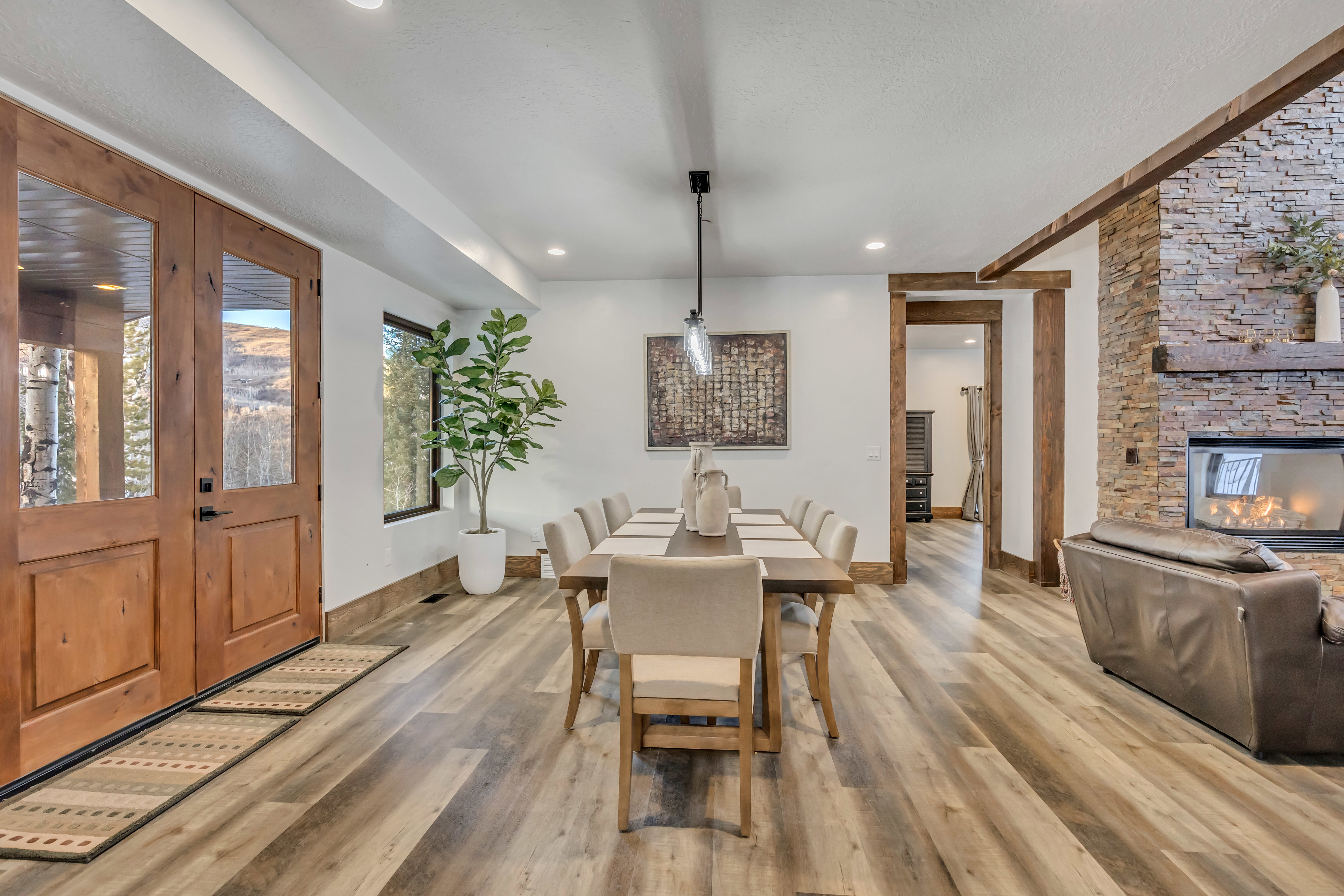 Dining room featuring a fireplace, light wood finished floors, and recessed lighting