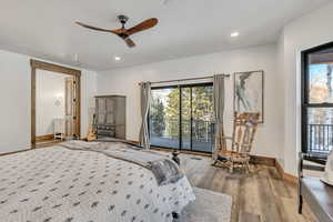 Bedroom featuring access to outside, a ceiling fan, wood finished floors, connected bathroom, and recessed lighting
