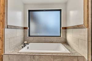 Bathroom featuring a bath and plenty of natural light