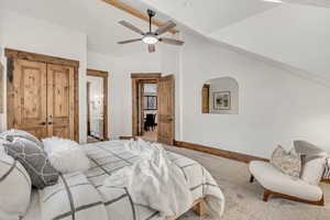 Carpeted bedroom with ensuite bathroom, a closet, and ceiling fan