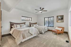 Carpeted bedroom with baseboards and ceiling fan