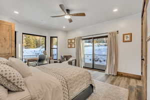 Bedroom with light wood-style floors, access to exterior, a ceiling fan, multiple windows, and recessed lighting