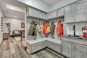 Mudroom with light wood-type flooring and recessed lighting
