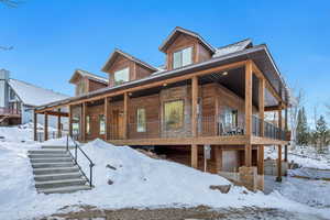 Rustic home featuring covered porch and a metal roof