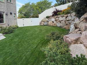 Fenced backyard featuring a gate