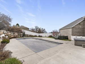 View of pool featuring a fenced backyard and patio surround