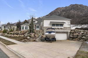 View of front of house featuring driveway, a garage, board and batten siding, and a mountain view