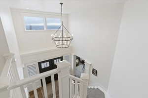 Detailed view of a chandelier and wood finished floors