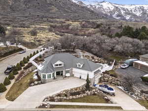 Aerial view of property and surrounding area with a mountain backdrop