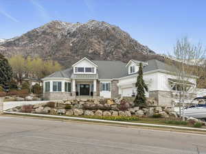 View of front of property with covered porch and a mountain view