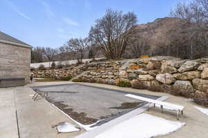 View of pool featuring a patio, a diving board, and a mountain view