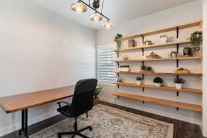 Office space with dark wood-style flooring