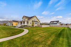Rear view of house featuring a residential view, covered porch, and a mountain view