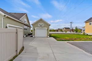 Garage featuring a residential view and concrete driveway