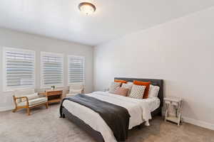 Bedroom featuring baseboards and light carpet
