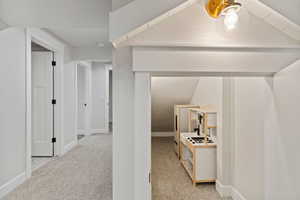 Corridor with light carpet and baseboards