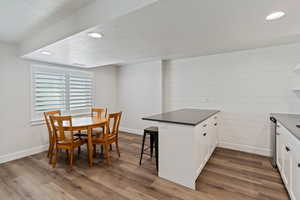Dining area featuring recessed lighting, a textured ceiling, and dark wood-style flooring