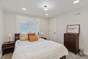 Carpeted bedroom with ornamental molding, recessed lighting, wood ceiling, and a closet
