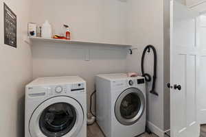 Laundry area featuring independent washer and dryer and baseboards