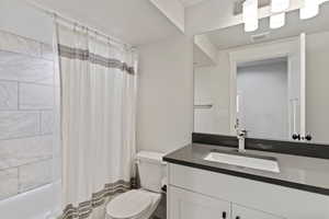 Full bath featuring vanity and shower / bathtub combination with curtain