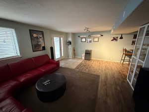 Living room with wood finished floors and plenty of natural light
