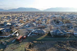 Aerial view of property and surrounding area featuring nearby suburban area