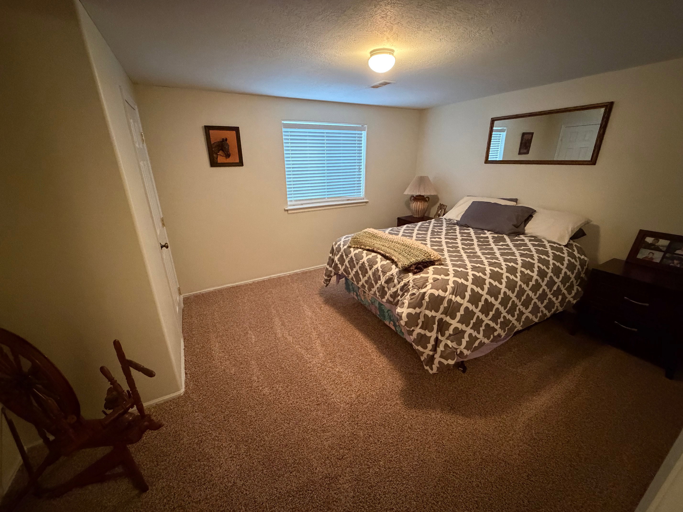 Bedroom featuring carpet and a textured ceiling