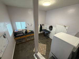 Laundry room with washer / dryer and a textured ceiling