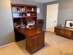 Office space featuring light colored carpet and baseboards