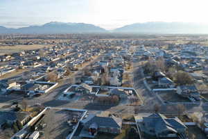Aerial view of property and surrounding area featuring nearby suburban area