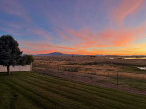 Yard at dusk featuring a mountain view