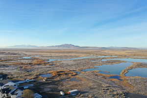 Overview of rural landscape featuring a mountain backdrop and a desert landscape